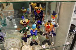 A group of five Murano glass clowns.