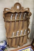 An unusual collection of Delft handled knives on an oak rack.