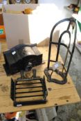 A cast iron boot jack / scraper together with a wrought iron saddle bracket and a cast iron