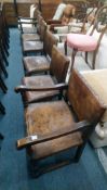 A set of six oak framed and leather upholstered dining chairs, two with arms.