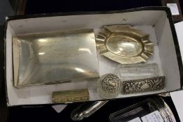 A silver cigarette box, an ashtray and other items.