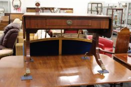 A Regency design mahogany sofa table with a single drawer on splay legs with brass caps and