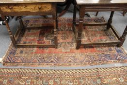 A Persian rug (worn).