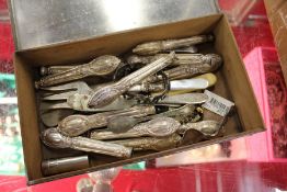 A box of silver cutlery handles.
