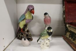 A group of porcelain bird ornaments.