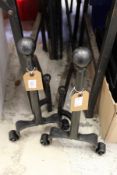 A pair of wrought iron firedogs.