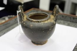 An early pottery twin handled vase.
