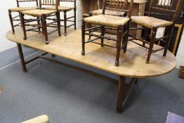 A good large pine trestle table with rounded rectangular top on chamfered square supports, united by