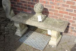 A weathered composite stone classical style bench.