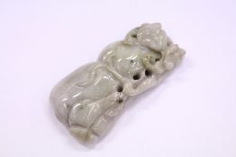 A carved jade amulet.