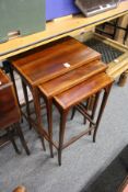 An Edwardian inlaid mahogany nest of tables.