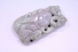 A carved jade amulet.
