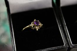 A 9ct gold and diamond and amethyst ring.