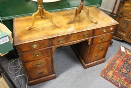 A walnut pedestal desk.