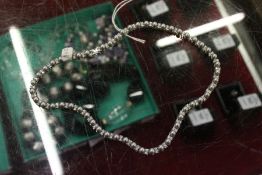 A decorative silver necklace set with pearls.