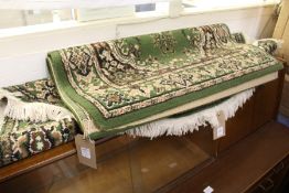 Two small green ground rugs.