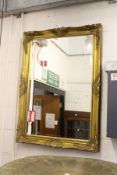 A large gilt framed mirror.