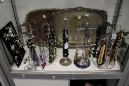 A large quantity of costume jewellery, mostly necklaces, complete with necklace stands.