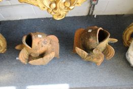 A pair of terracotta fish shaped garden plabters.