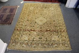 A Persian rug, light beige ground with floral decoration.