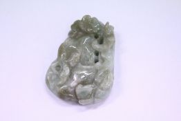 A carved jade amulet.