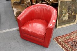 A red leather cloth upholstered tub armchair.