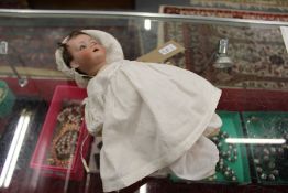 A porcelain headed doll.