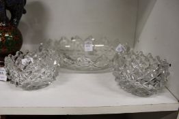 A cut glass dish and a pair of similar smaller dishes.