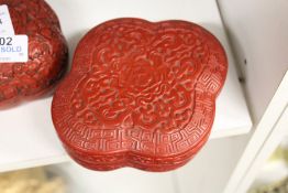 A Chinese carved cinnabar lacquer box and cover.