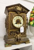 A decorative 19th century cast brass mantle clock.