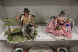 A Capodimonte tramp on a bench and a porcelain figural group.