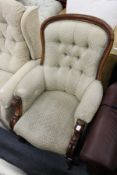 A Victorian button upholstered mahogany framed armchair.