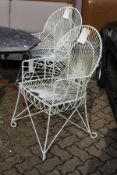 A good pair of painted wrought iron wirework armchairs.