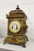 A decorative cast brass mantle clock.
