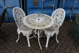 A patio table and a pair of chairs.