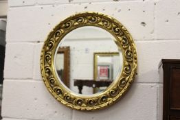 A gilt framed circular mirror.