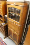 A 1940's oak narrow secretaire cupboard bookcase.