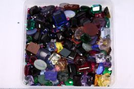 A quantity of mixed semi-precious stones to include blue agate, gold stone, tiger's eye etc. etc.