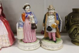A pair of porcelain figural match strikers.