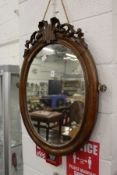 A mahogany framed oval wall mirror.