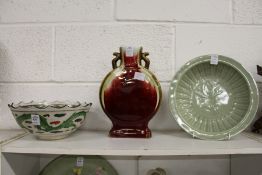 A Chinese bowl decorated with a dragon, a moon flask and a celadon dish.