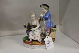 A continental porcelain group of a young boy with a pipe, the girl seated with a goat eating