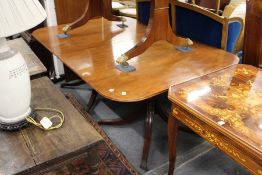 A good George III design mahogany twin pillar dining table with one leaf.