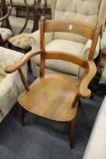 A Victorian beech kitchen armchair.