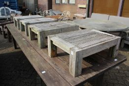 A set of four hardwood garden stools / occasional tables.