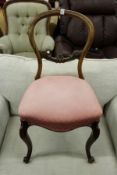 A Victorian walnut balloon back dining chair.