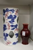 A Chinese under glazed blue and iron red porcelain hat stand and a sang de boeuf vase.