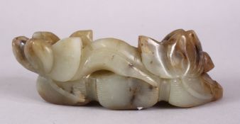 A CARVED CHINESE JADE LOTUS FORM STAND, carved with lotus emerging from the ground, 15cm.