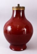 A CHINESE SANG DE BOEUF PORCELAIN VASE / LAMP, with a deep ox blood red ground with a cracling to