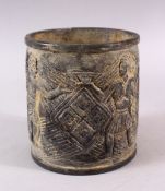 AN EASTERN? STONE CARVED FIGURAL BRUSH POT / VASE, carved with figures, 16cm high x 14cm diameter (